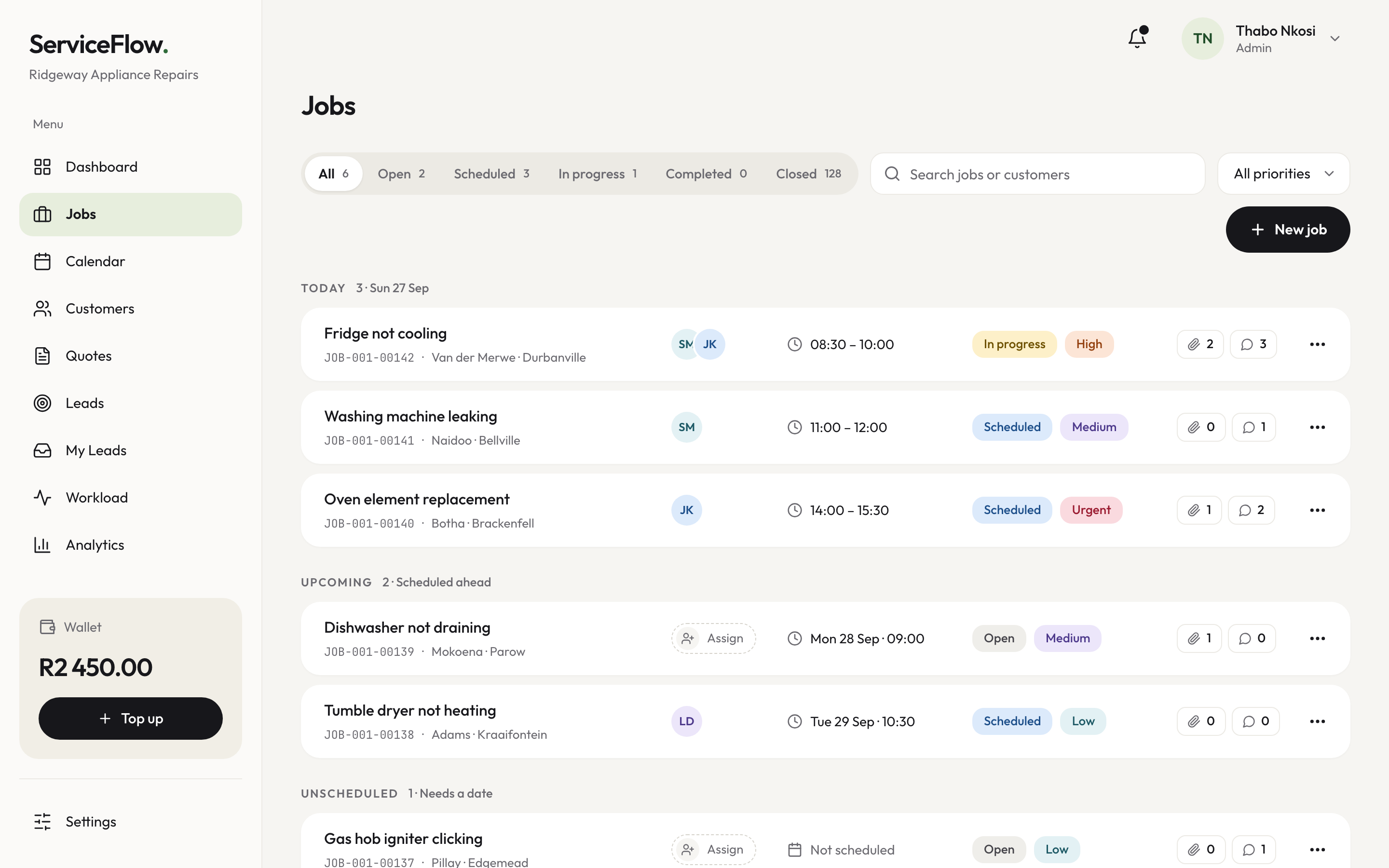 The job app on a laptop: today's appliance repair jobs, with times, technicians and status